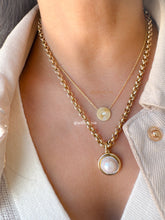 Load image into Gallery viewer, Close up of Willow Roe 14K Gold layered necklaces featuring gold Pleated  diamond disc pendant and a bold link chain with large pearl pendant on model 
