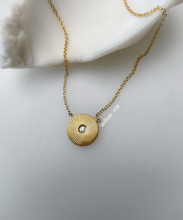 Load image into Gallery viewer, Willow Roe 14K gold celestial sunburst pendant necklace with a center diamond accent on a white background. 
